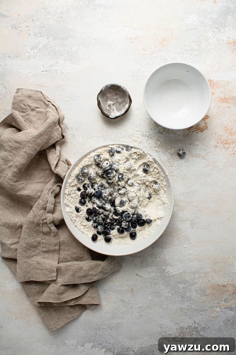 Mixing together blueberry muffin batter.