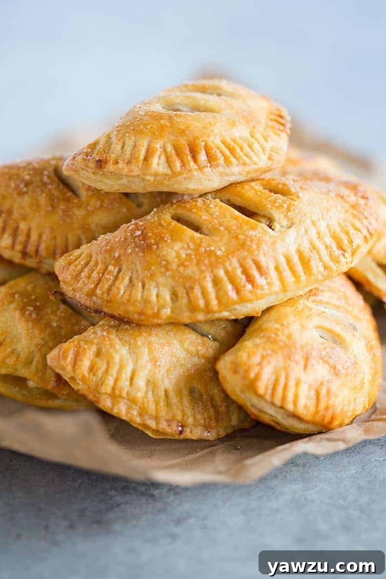 Golden-brown Apple Hand Pies with a perfectly flaky crust, filled with spiced apples.