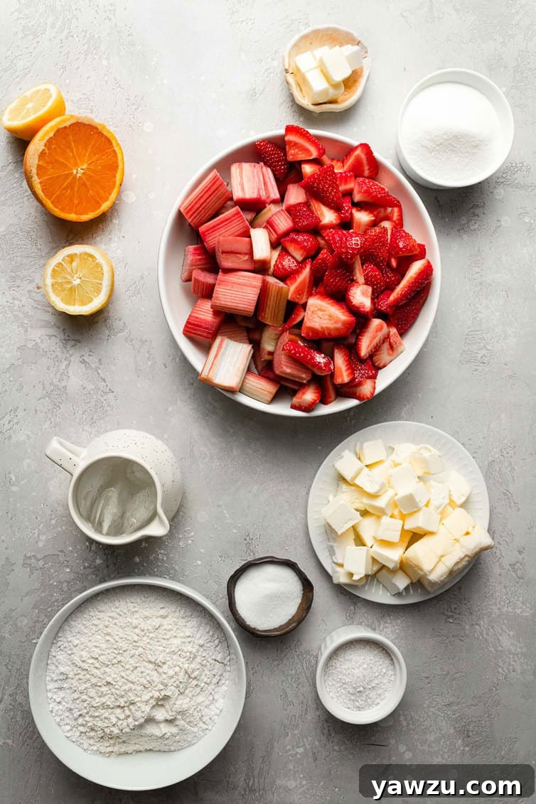 Ingredients for strawberry rhubarb pie prepped in bowls on counter.