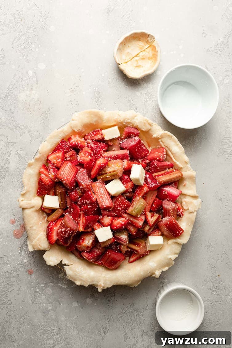 Strawberry rhubarb pie filling in an unbaked pie shell.