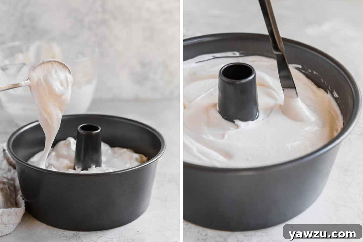 Angel food cake batter being spooned into an ungreased tube pan and a butter knife run through it to release air bubbles, ready for baking.