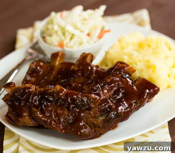Tender Slow Cooker BBQ Ribs coated in a rich, sweet, and smoky sauce