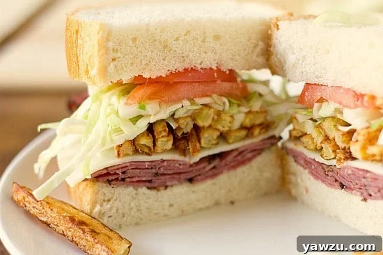 A classic homemade Primanti Bros. sandwich, overflowing with pastrami, provolone cheese, crispy French fries, and tangy coleslaw.