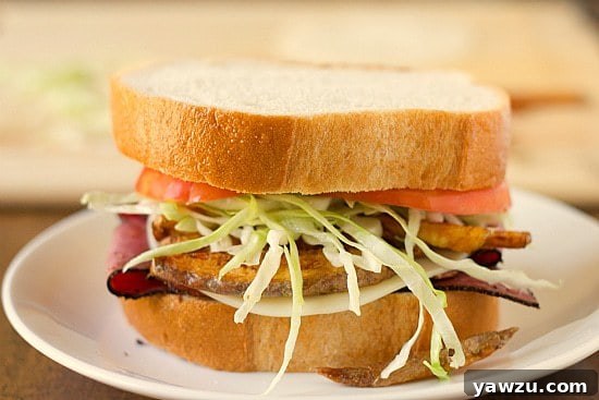The completed homemade Primanti Bros. sandwich, with all layers perfectly stacked and topped with the second slice of Italian bread, ready to be enjoyed.