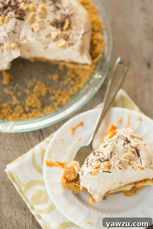 Indulgent Banoffee Pie with layers of rich toffee, fresh bananas, and fluffy whipped cream, topped with chocolate shavings.