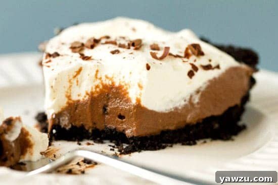 A rich and creamy Chocolate Cream Pie, topped with elegant chocolate curls and a luscious whipped cream.