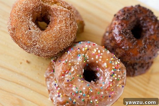 Freshly fried homemade buttermilk doughnuts cooling on a wire rack, ready for glazing or sugar coating.
