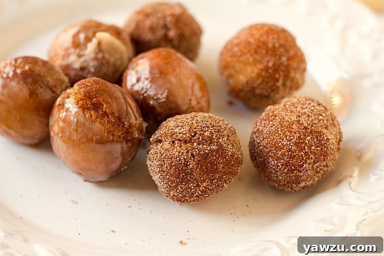 Close-up of golden-brown homemade doughnut holes, perfectly fried and ready for a dusting of sugar.