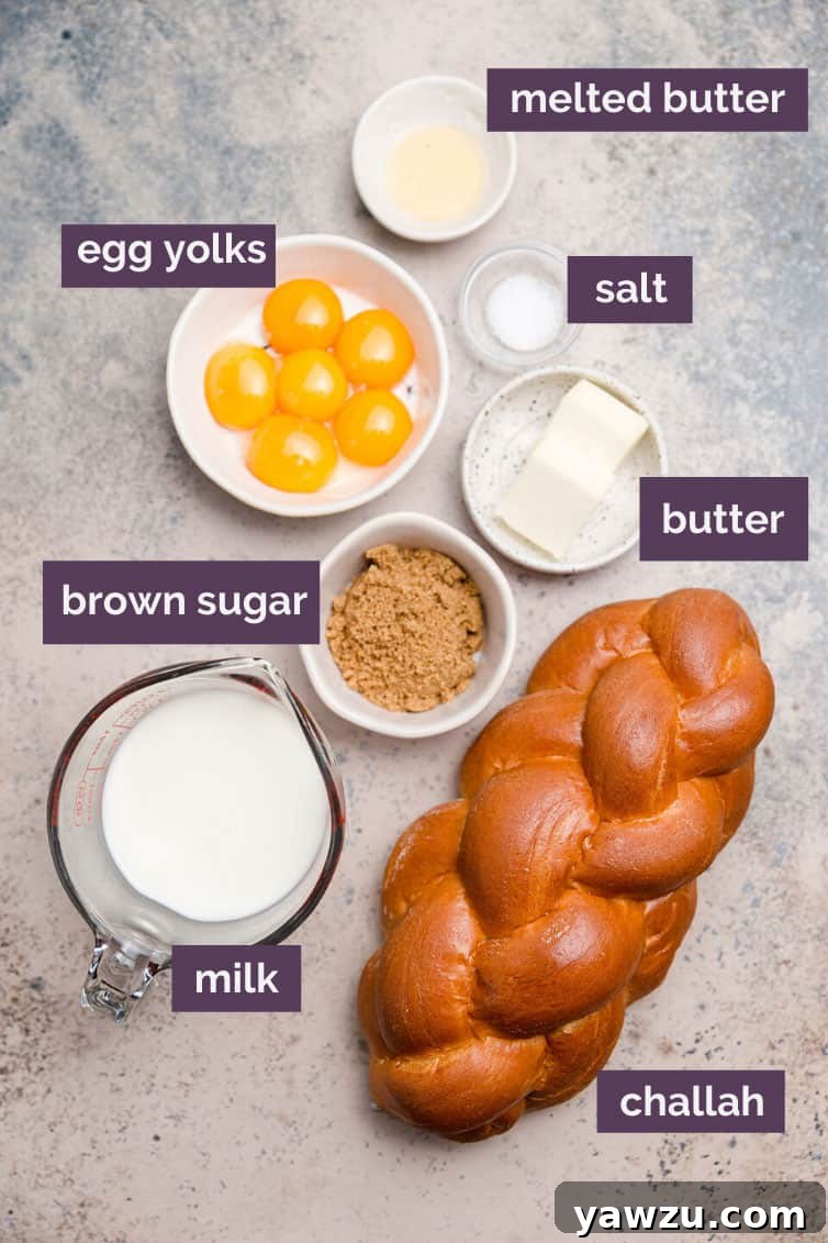 A collection of fresh ingredients for French toast including challah bread, eggs, milk, sugar, and vanilla, prepped on a kitchen counter.