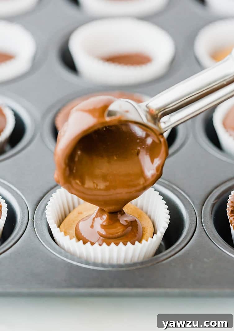 Scooping melted chocolate on top of peanut butter filling.