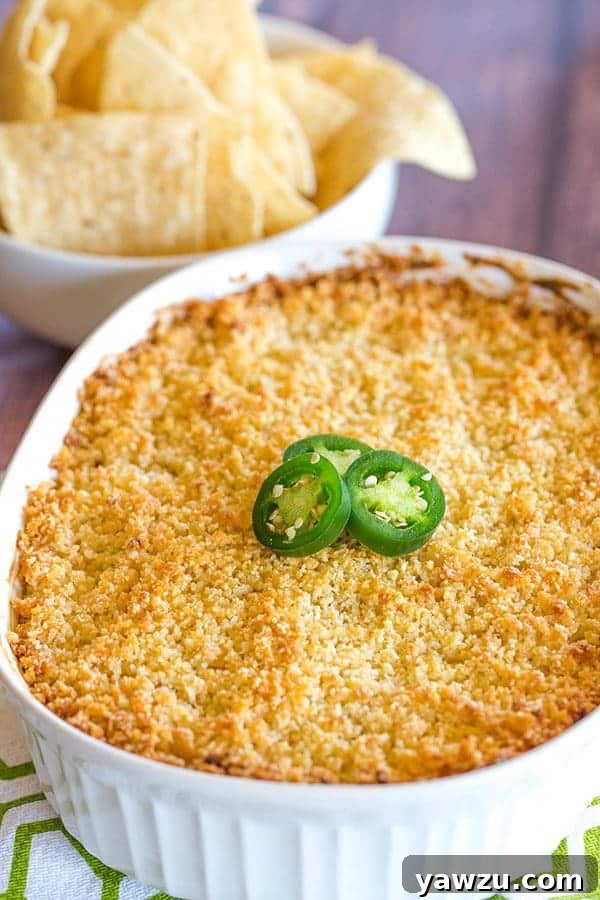 Close-up of bubbling Jalapeño Popper Dip with a golden breadcrumb topping, fresh out of the oven.