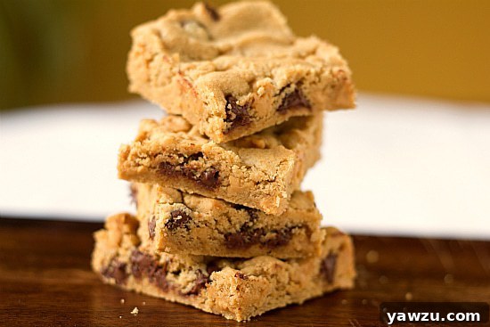 Delicious Peanut Butter Chocolate Chip Cookie Bars on a wooden surface, ready to be enjoyed.