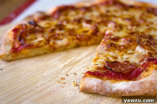 Another view of the cooked pepperoni pizza on a wooden board