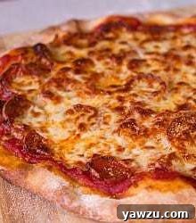 Pepperoni pizza on a wood cutting board after baking.