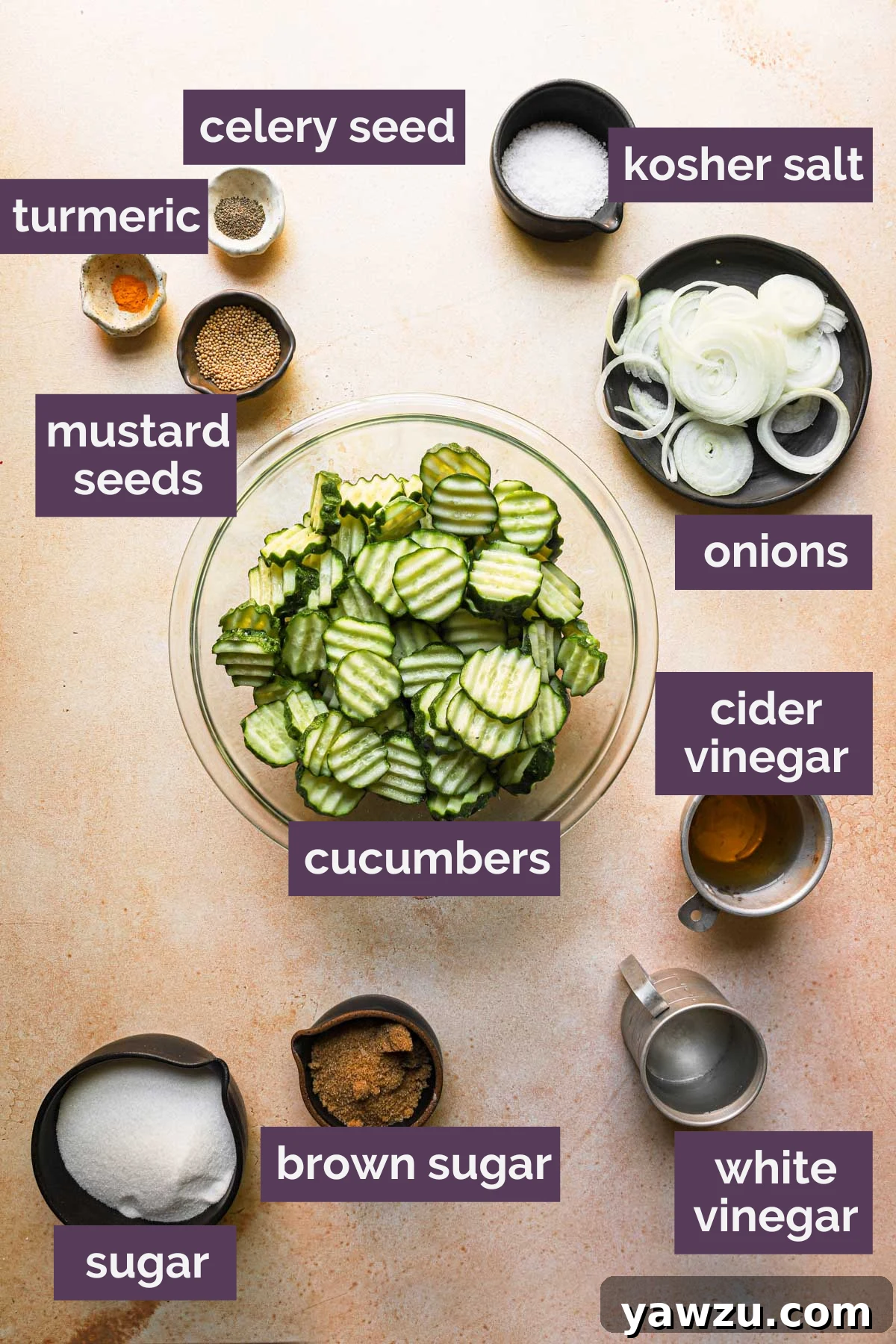 All the fresh ingredients for homemade bread and butter pickles, including sliced cucumbers, onions, and various spices, prepped and laid out on a clean surface.