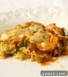 A serving of garden zucchini pizza casserole on a white plate.
