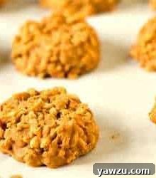 No-bake peanut butter butterscotch cookies on a parchment paper lined baking sheet.