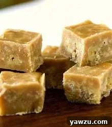 Squares of maple walnut fudge on a wood board.