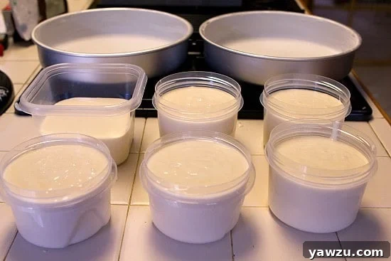 White cake batter evenly divided into six separate clear plastic bowls