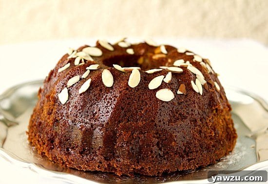 A beautifully presented Honey Cake dusted with powdered sugar and adorned with slivered almonds