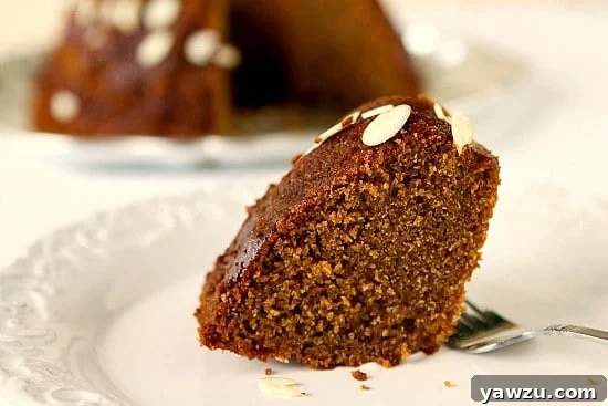 Freshly baked Honey Cake cooling on a wire rack, garnished with slivered almonds