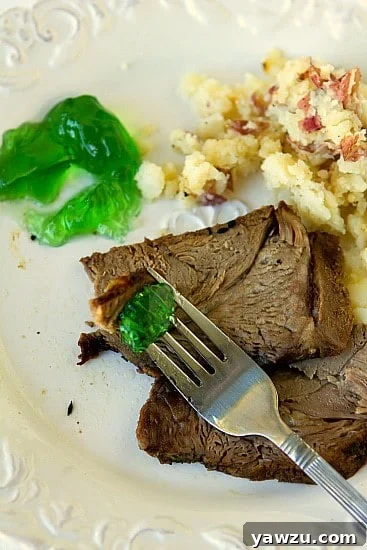 Close-up of the crispy, spiced crust on a roasted lamb joint, showcasing the texture and aromatic blend of cumin and fennel seeds.