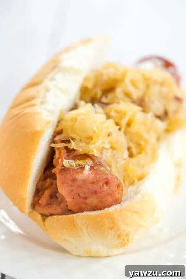 This slow cooker kielbasa and sauerkraut is flavorful and made with just the addition of beer and brown sugar - easy, delicious and perfect for parties!
