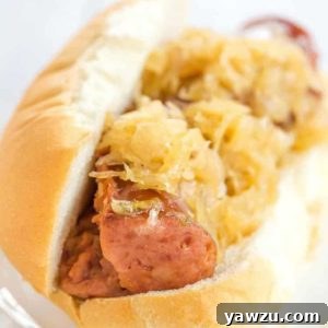 This slow cooker kielbasa and sauerkraut is flavorful and made with just the addition of beer and brown sugar - easy, delicious and perfect for parties!