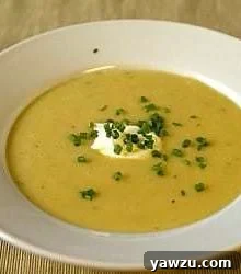 Creamy potato and leek soup in a white bowl, ready to be served.
