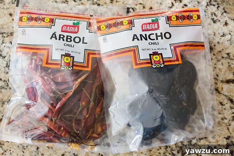 Bags of dried ancho and dried arbol chiles, essential for creating an authentic and deeply flavorful homemade chili paste.