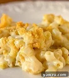 A close-up of a serving of macaroni and cheese casserole on a white plate, highlighting the crispy topping and creamy interior.
