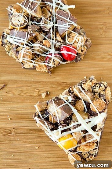 A selection of chopped Halloween candies, including Butterfingers, Heath bars, and Reese's Peanut Butter Cups, on a cutting board, ready for the bark.