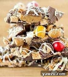 A close-up shot of a stack of Leftover Halloween Candy Bark, highlighting the rich chocolate, colorful candies, and appealing textures.