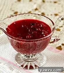 Cranberry sauce in a glass serving bowl, ready for the table.