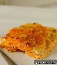 Serving of sweet potato gratin on a white plate with a fork.