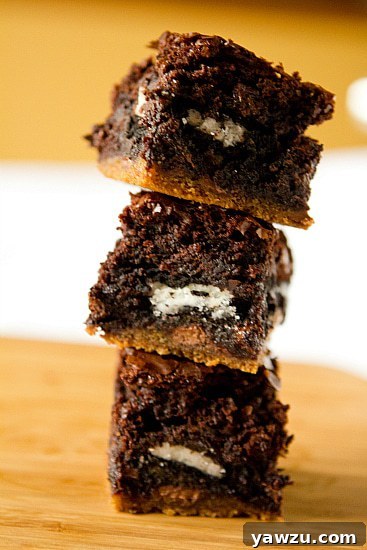 Close-up of a stack of Chocolate Chip Cookie & Oreo Fudge Brownie Bars