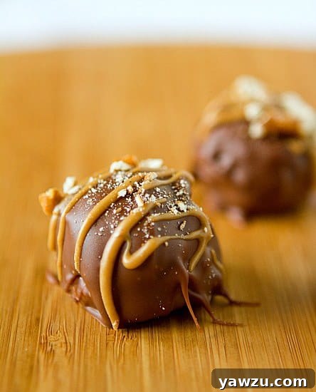 Delicious Peanut Butter-Pretzel Truffles arranged beautifully on a rustic wooden board, ready to be enjoyed.