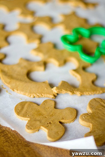 Decorated Gingerbread Man Cookies, ready for the holidays, arranged artfully on a white surface.