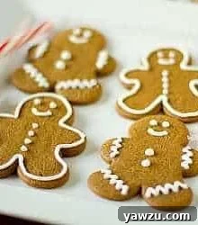 Decorated gingerbread men cookies on a white plate.