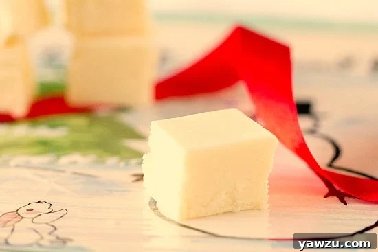 Several pieces of festive eggnog fudge artfully arranged on a plate.