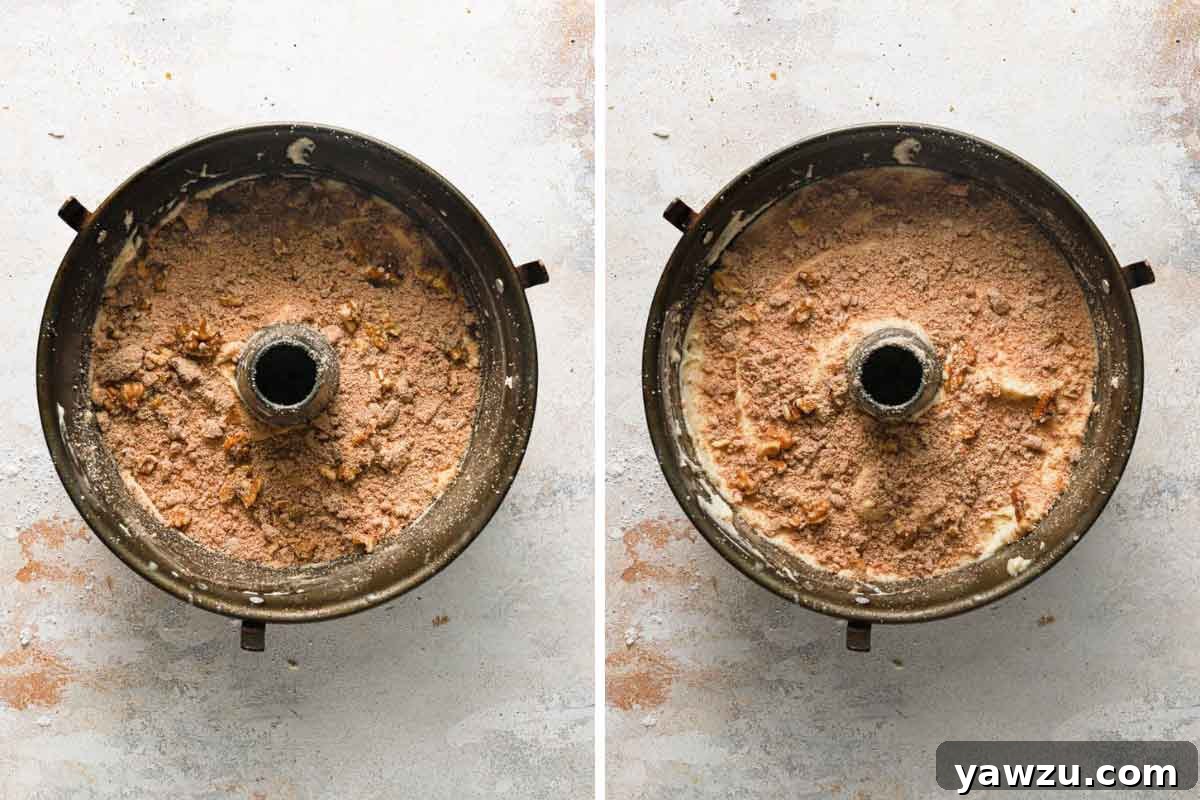 Sour cream coffee cake assembled with alternating layers of cake batter and streusel in a tube pan.