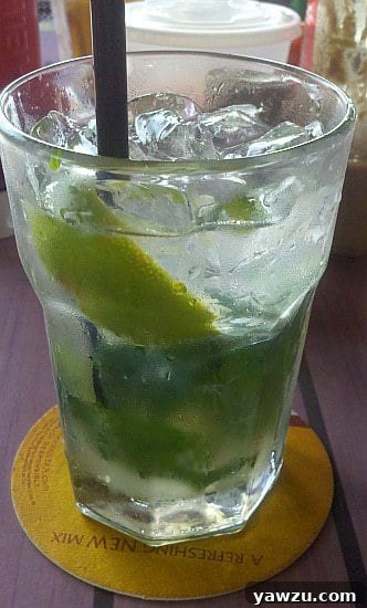 A refreshing Mojito cocktail with lime and mint garnish