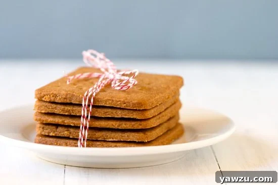 Golden homemade graham crackers stacked, ready for snacking or s'mores.