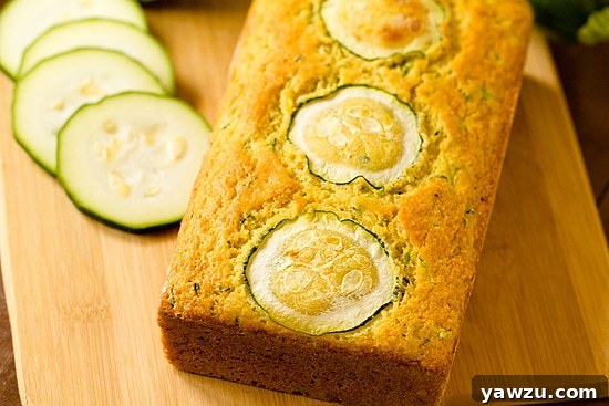 A slice of Zucchini Cornbread on a cutting board
