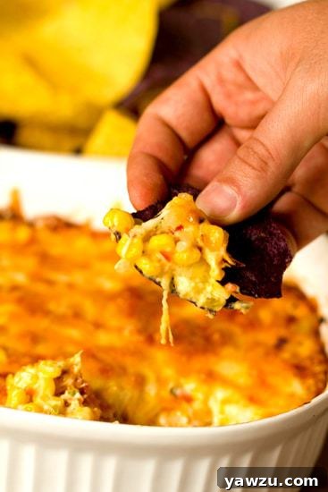 Close-up of a spoon digging into Hot Corn Dip