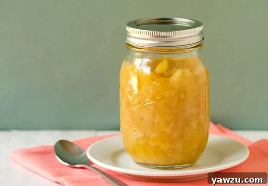 Homemade Pineapple Ice Cream Topping in a bowl, showcasing its chunky texture and vibrant color.