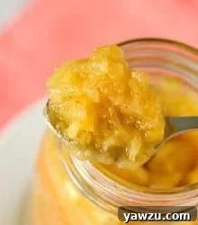 Homemade Pineapple Ice Cream Topping in a glass jar.