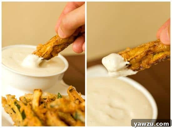 A basket of golden-brown beer-battered zucchini fries, perfectly cooked and ready to serve.