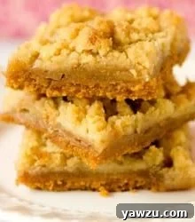 A top-down view of a single Dutch Apple Pie Bar, showing its rich layers and golden streusel.