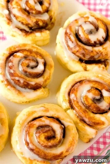 Freshly baked Cinnamon Roll Biscuits drizzled with sweet icing, ready to be served for breakfast or brunch.